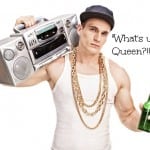 Young male rapper carrying a ghetto blaster over his shoulder and holding a bottle of beer isolated on white background