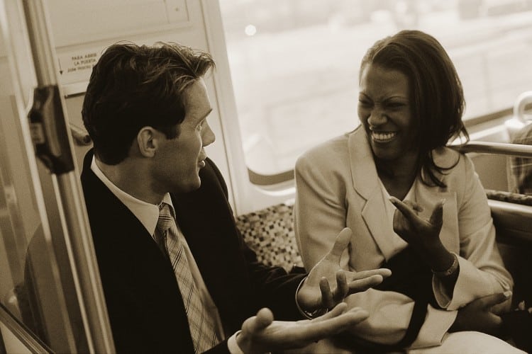Business People Conversing on Train