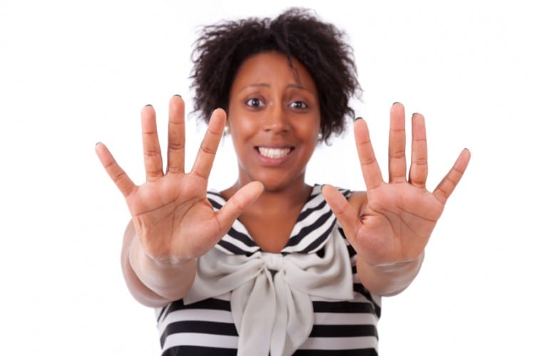 Young black woman showing her  hands palm - African people