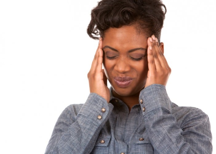 casual black woman with headache on white background