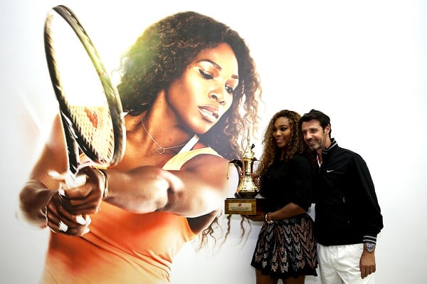 ISTANBUL, TURKEY - OCTOBER 25: Serena Williams of the United States and coach Patrick Mouratoglou of France pose for photographers after the ceremony for the WTA Year End No. 1 Singles presented by Dubai Duty Free trophy during day four of the TEB BNP Paribas WTA Championships at the Sinan Erdem Dome on October 25, 2013 in Istanbul, Turkey. (Photo by Matthew Stockman/Getty Images)