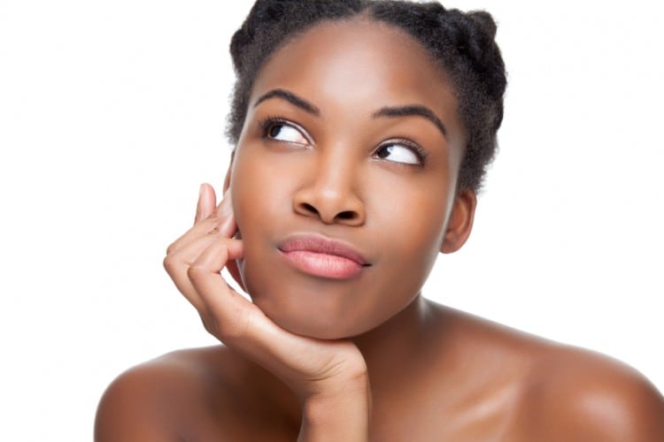 Beautiful young black woman looking up