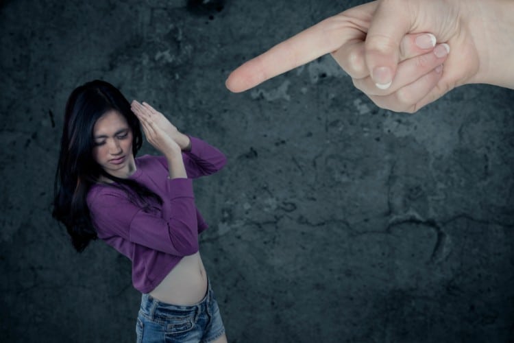 Teenage girl with long hair looks fear and sad when scolded by someone
