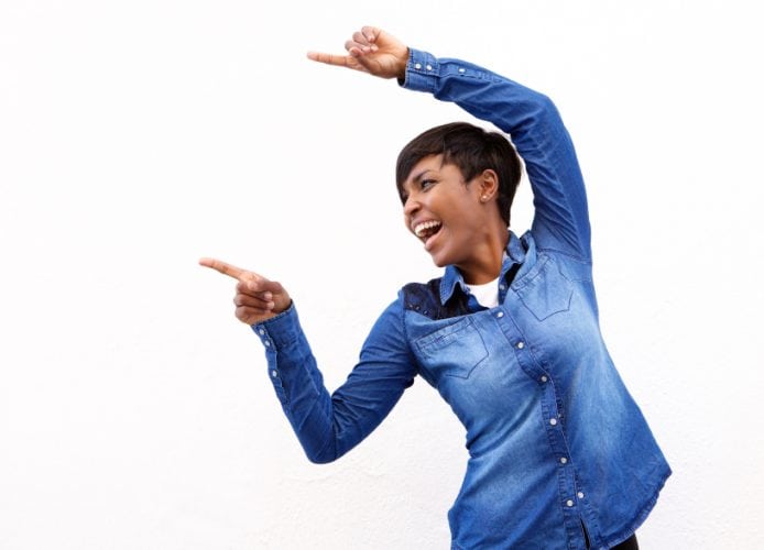 Portrait of a cheerful young african american woman pointing fingers
