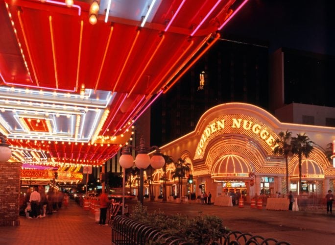 Las Vegas, United States - October 20, 1994: Golden Nugget casino in the downtown district at night with tourist walking by, Las Vegas, Nevada, USA.