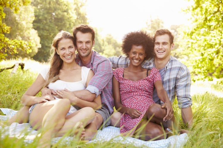 Two couples relaxing together in the countryside
