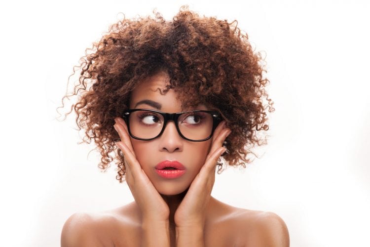Portrait of young beautiful african american girl with afro. Girl wearing eyeglasses. Closeup photo. Studio shot.