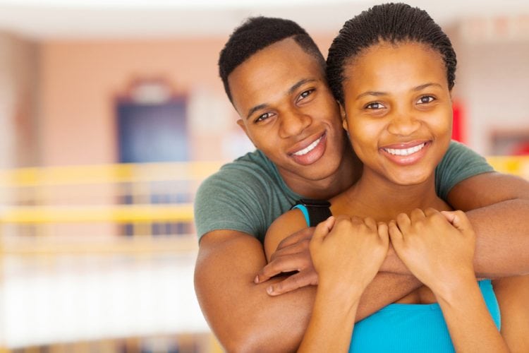 close up portrait of smiling afro american college couple