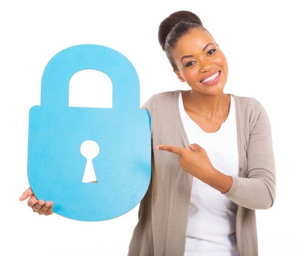 portrait of gorgeous young african american woman pointing a large security lock symbol