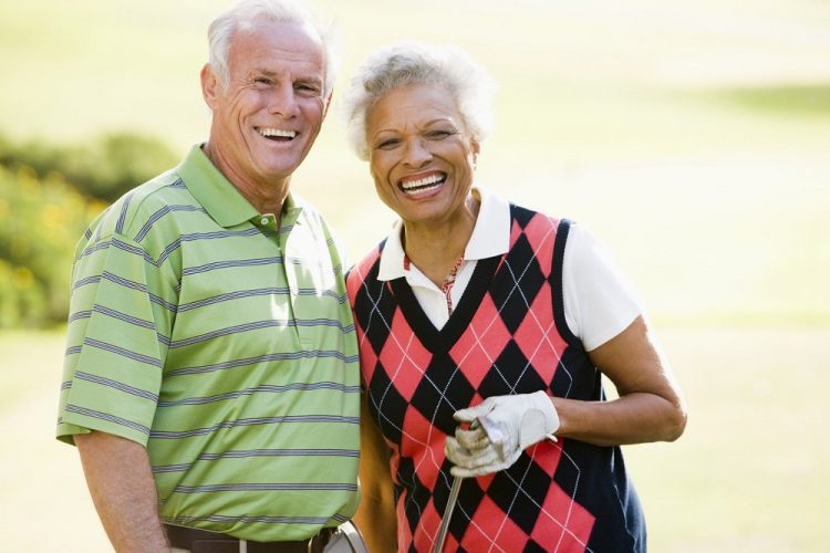 old black and white interracial couple playing golf